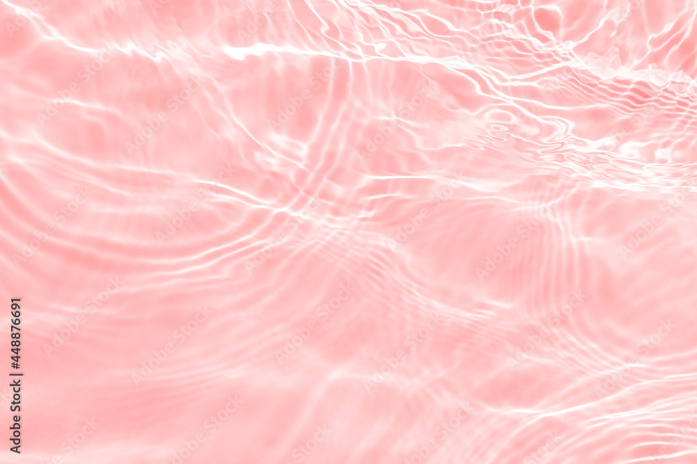 Surface of light toned in pink transparent swimming pool water texture with circles on the water. Trendy abstract nature background. Water waves in sunlight banner with copy space. Surface of light toned in pink transparent swimming pool water texture with circles on the water. Trendy abstract nature background. Water waves in sunlight banner with copy space.
