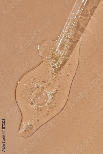 Cosmetic lotion spilled from pipette photo