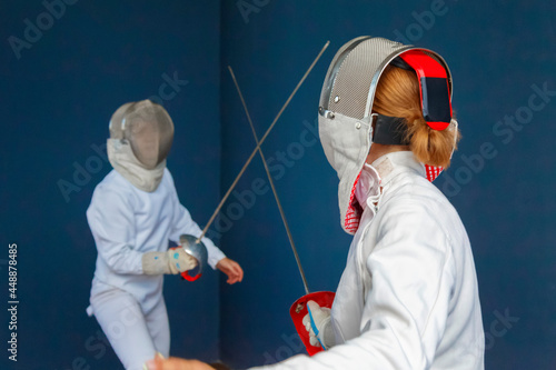 Anonymous women having fencing training together photo