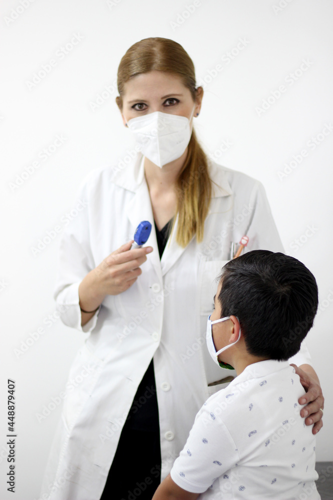 Female professional pediatrician doctor working checking a happy latin child
Female professional pediatrician doctor working checking a happy latin child