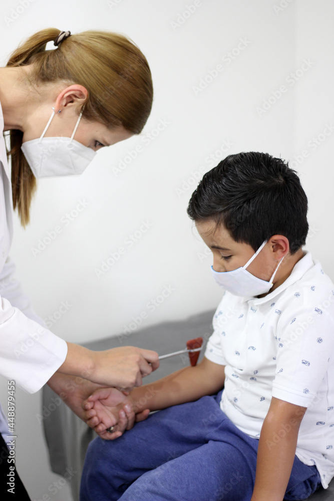 Female professional pediatrician doctor working checking a happy latin child
Female professional pediatrician doctor working checking a happy latin child