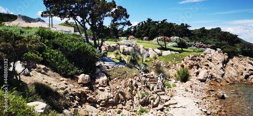 High angle shot of a landscape with rocky hill and green trees in Pevero in Sardegna photo