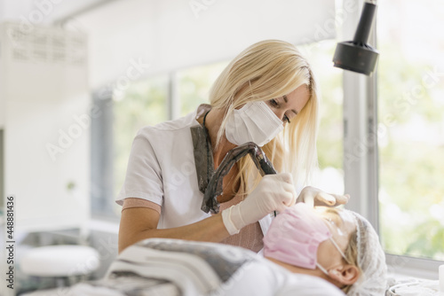 Cosmetologist doing micropigmentation photo