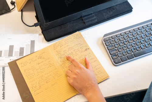 Close up of working with notebook and computer