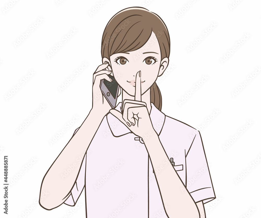 スマートフォンを持ち、人差し指を口にあてる看護師 スマートフォンを持ち、人差し指を口にあてる看護師