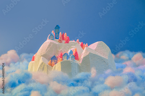 Miniature snowy village on cloud photo