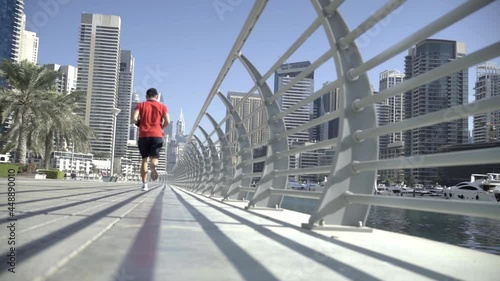 Wallpaper Mural a man is engaged in a morning jog along the embankment of Dubai Marina Torontodigital.ca