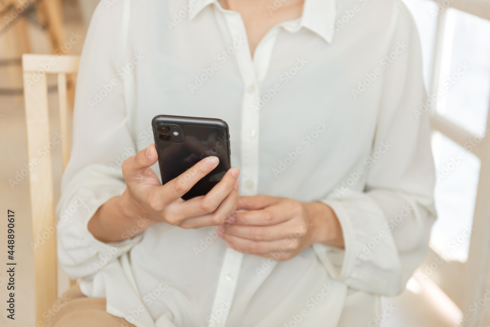using cell phone hand holding mobile texting message contact us.chatting,search internet information in office.technology device communication connecting using cell phone hand holding mobile texting message contact us.chatting,search internet information in office.technology device communication connecting