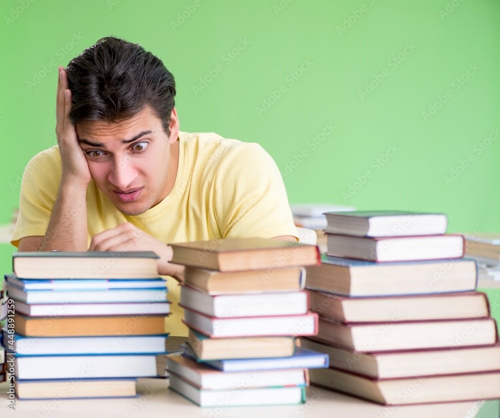 Student with too many books to read before exam Student with too many books to read before exam