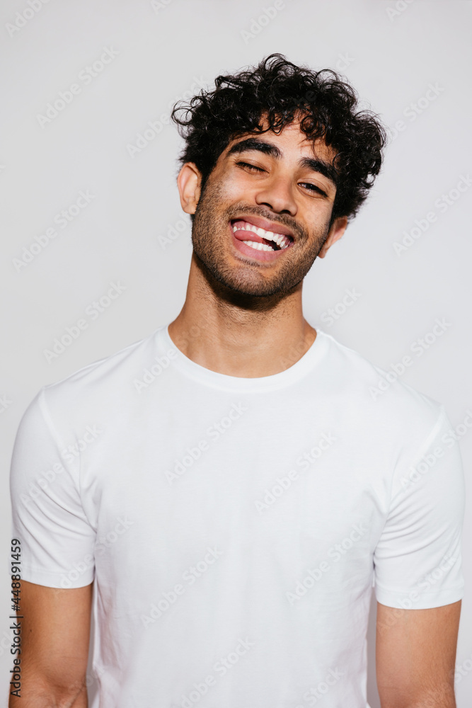 Happy Hispanic guy biting tongue Happy Hispanic guy biting tongue