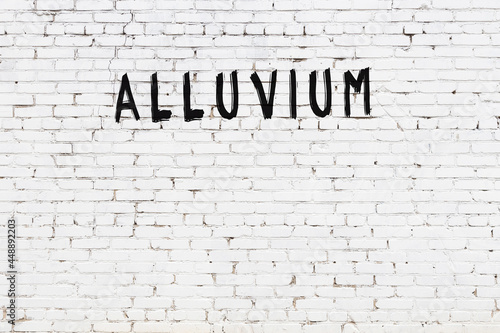 White wall with black paint inscription alluvium on it