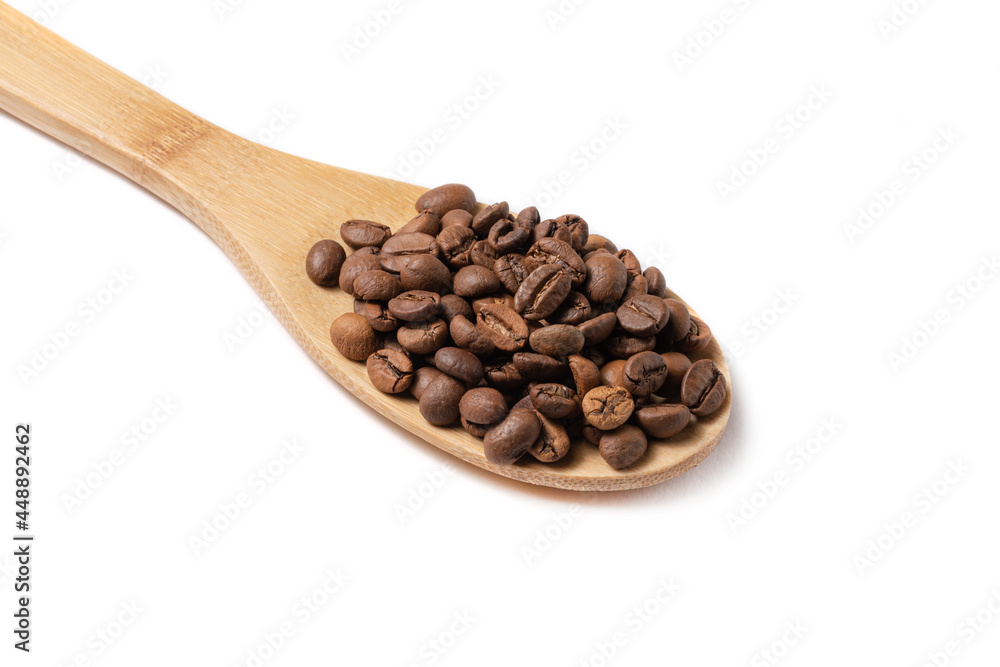 Fototapeta premium Coffee beans on wood spoon isolated on white background