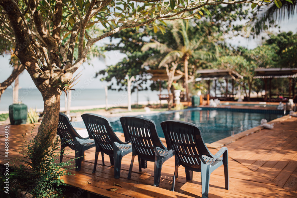 deckchairs on swimming pool.Luxury swimming pool.