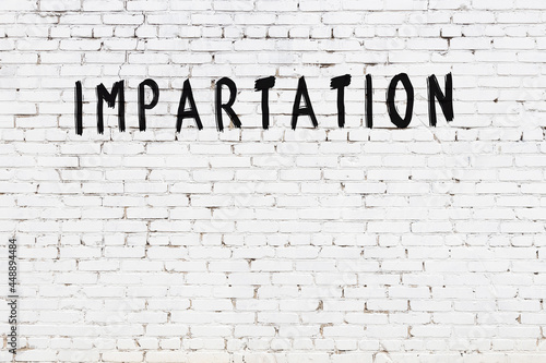 White wall with black paint inscription impartation on it
