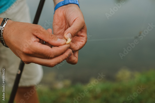 A man preparing maggot for fishing photo