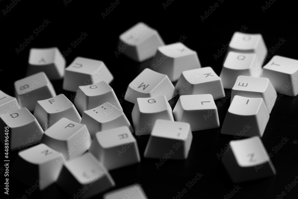 Random letters of keycaps or keyboard buttons on black background. Random Alphabet. Random letters of keycaps or keyboard buttons on black background. Random Alphabet.