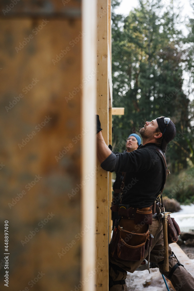 Carpenter working on the job site in winter Carpenter working on the job site in winter