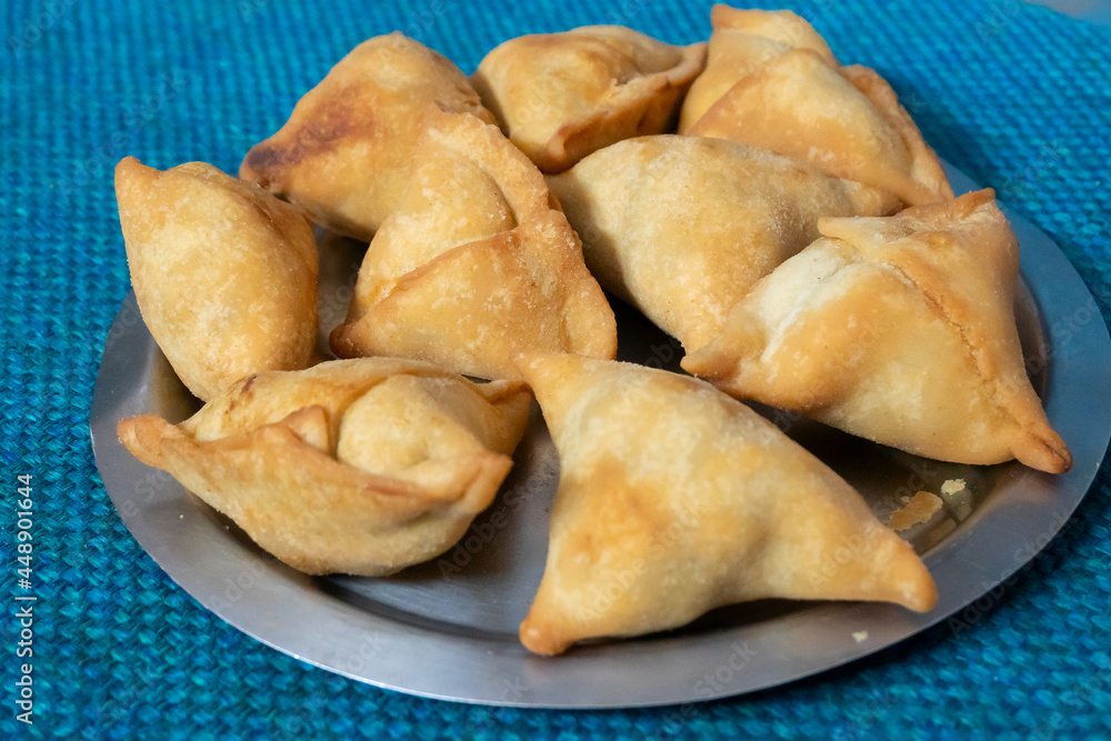 Homemade Samosa, samsa or smosa. A vegetarian spicy Indian special traditional street food. Iftaari dish, Selective focus. Homemade Samosa, samsa or smosa. A vegetarian spicy Indian special traditional street food. Iftaari dish, Selective focus.