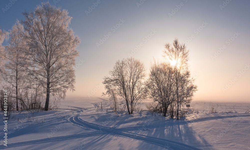 A sunny winter morning. A ski run in the snow leads to the fog A sunny winter morning. A ski run in the snow leads to the fog