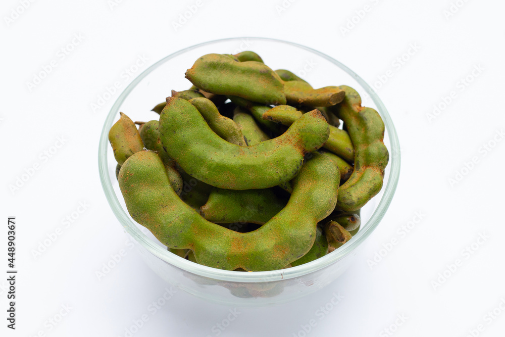 Young tamarind in glass bowl on white background. Young tamarind in glass bowl on white background.