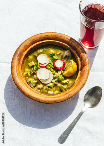 Homemade green pozole with drink photo