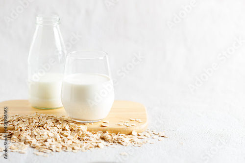 glass of oat milk and bottle