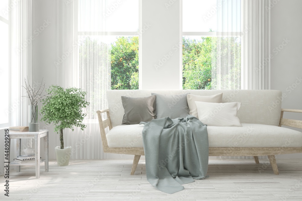 Fototapeta premium White living room with sofa and summer landscape in window. Scandinavian interior design. 3D illustration