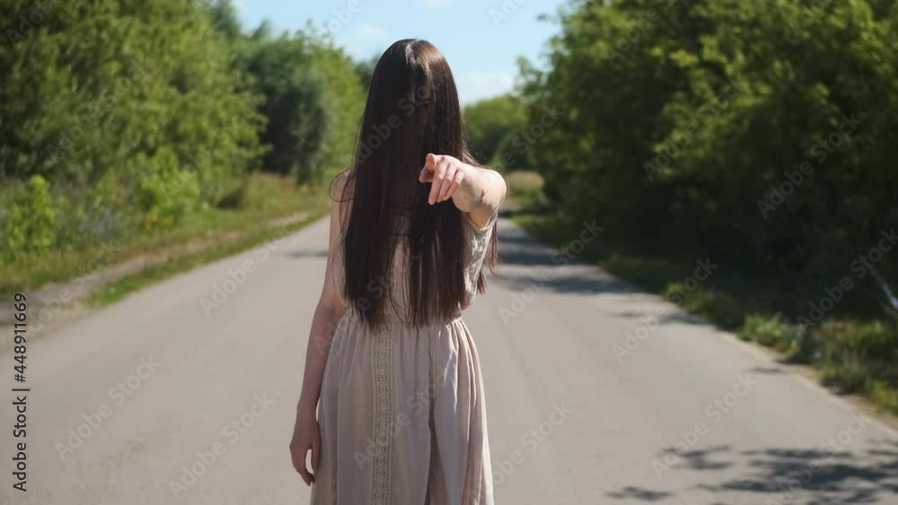 scary ghost woman in an old dress with hair covering her face, shows her finger at the camera. Horror on the road creepy day for travelers. scary ghost woman in an old dress with hair covering her face, shows her finger at the camera. Horror on the road creepy day for travelers.