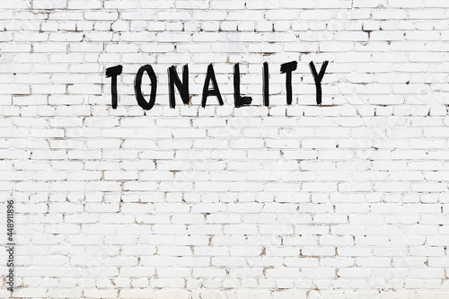 White wall with black paint inscription tonality on it