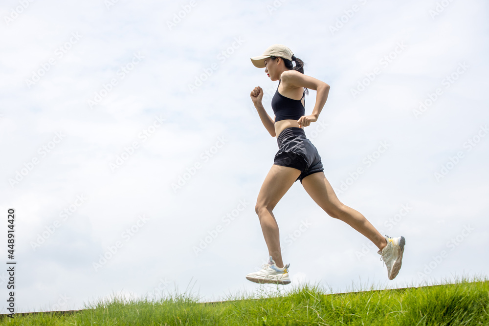 Young Asian girls running in the morning for fitness Young Asian girls running in the morning for fitness