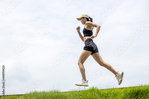 Fototapeta Naklejka Na Ścianę i Meble -  Young Asian girls running in the morning for fitness