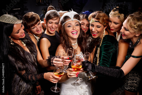 Beautiful women in evening dresses with champagne glasses