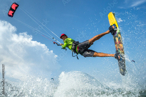 A kite surfer rides the waves
