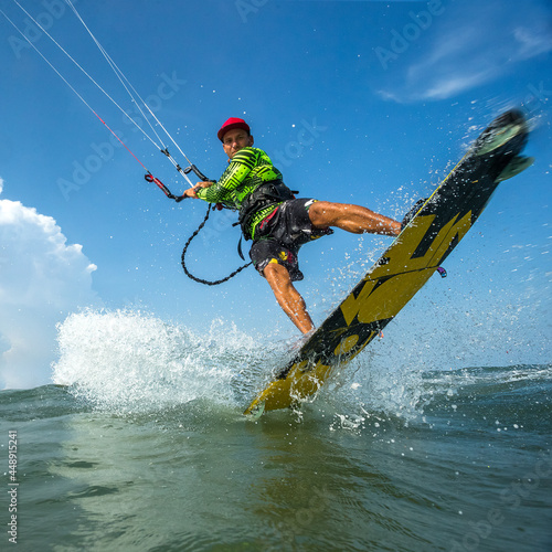 A kite surfer rides the waves 