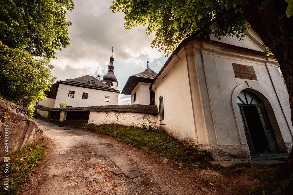 Church in The Spania Dolina village with mining landscape, Slovakia, Europe. - obrazy, fototapety, plakaty 