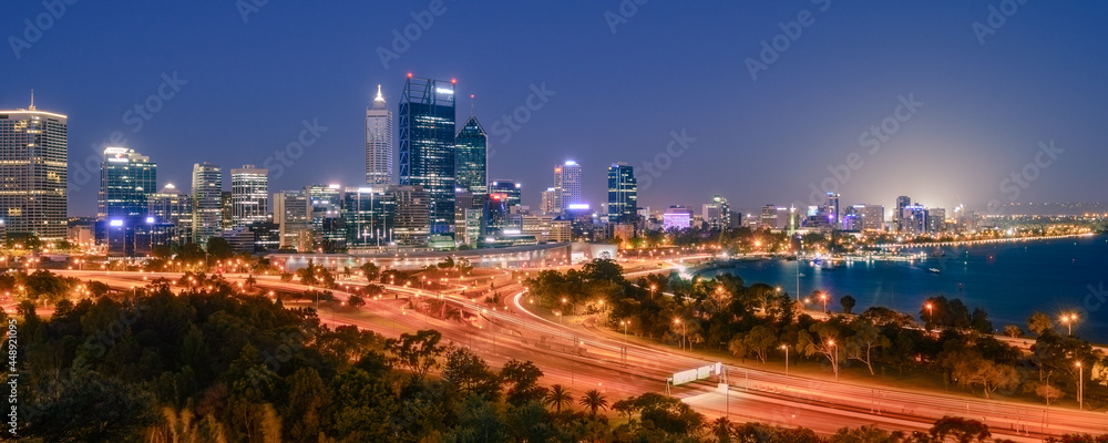 Panoramic view of Perth city buildings and the Mitchell Freeway viewed at night from Kings Park. Perth is a modern and vibrant city and is the state capital of Western Australia, Australia.