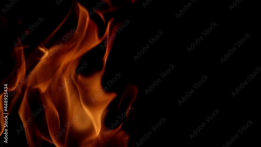 slow motion video with bright orange flame with sparks on dark background slow motion video with bright orange flame with sparks on dark background