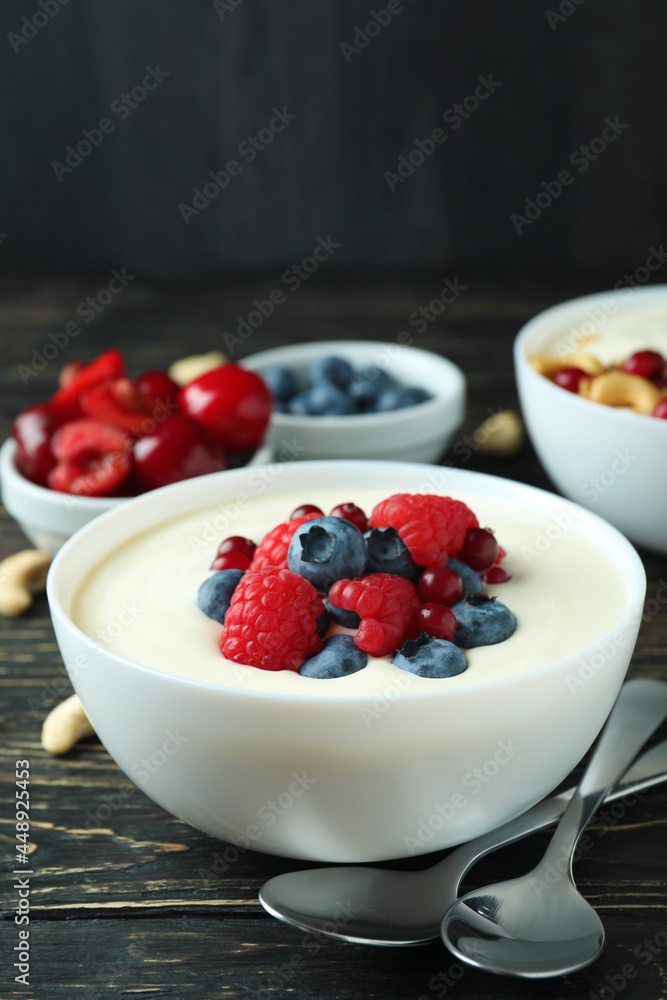 Concept of tasty breakfast with yogurt on wooden table Concept of tasty breakfast with yogurt on wooden table