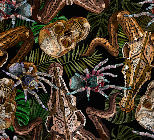 Gothic embroidery. Human skulls, pal leaves, tarantula spider and bull head, clothes background. Tropical seamless pattern. Halloween dark background. Fashionable template for clothes