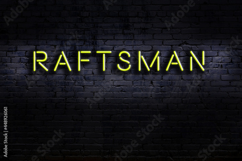 Neon sign. Word raftsman against brick wall. Night view photo