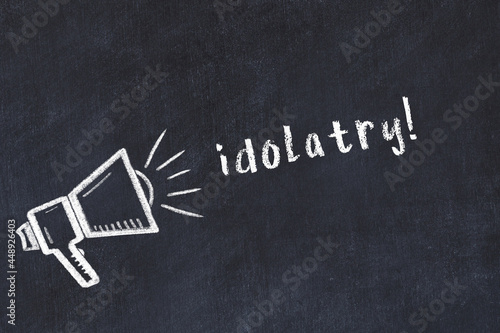 Chalk sketch of loudspeaker and inscription idolatry