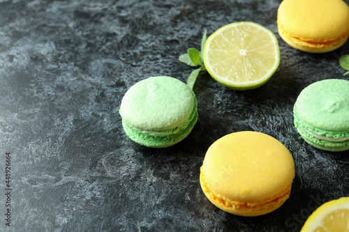 Concept of tasty dessert with macaroons on black smokey background