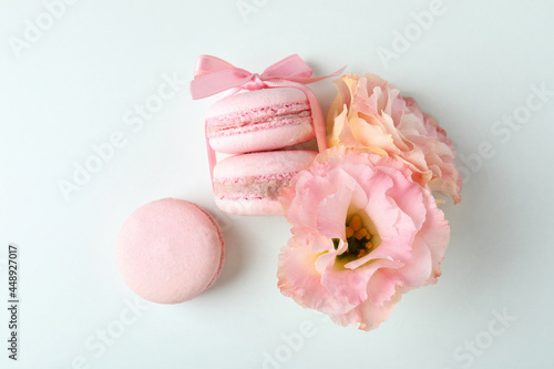 Concept of tasty dessert with macaroons on white background