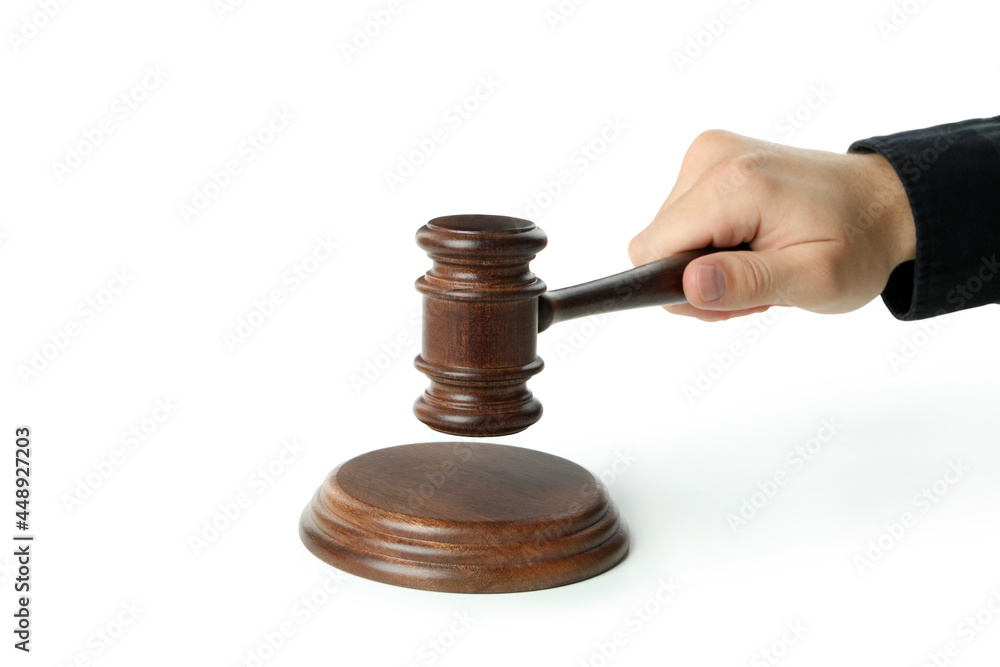 Male hand holds judge gavel, isolated on white background Male hand holds judge gavel, isolated on white background