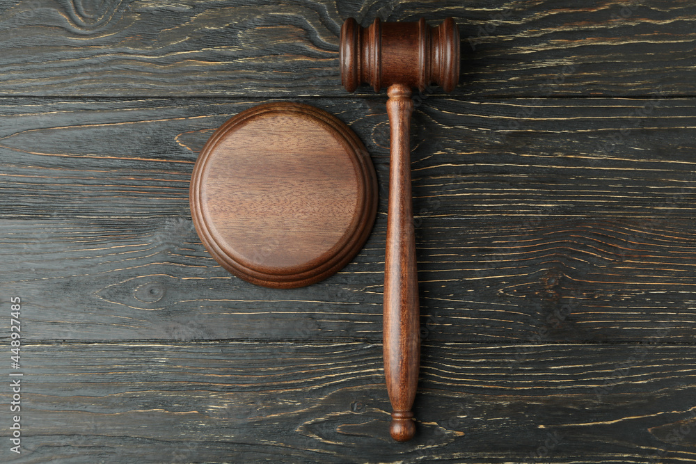 Judge gavel on rustic wooden background, top view