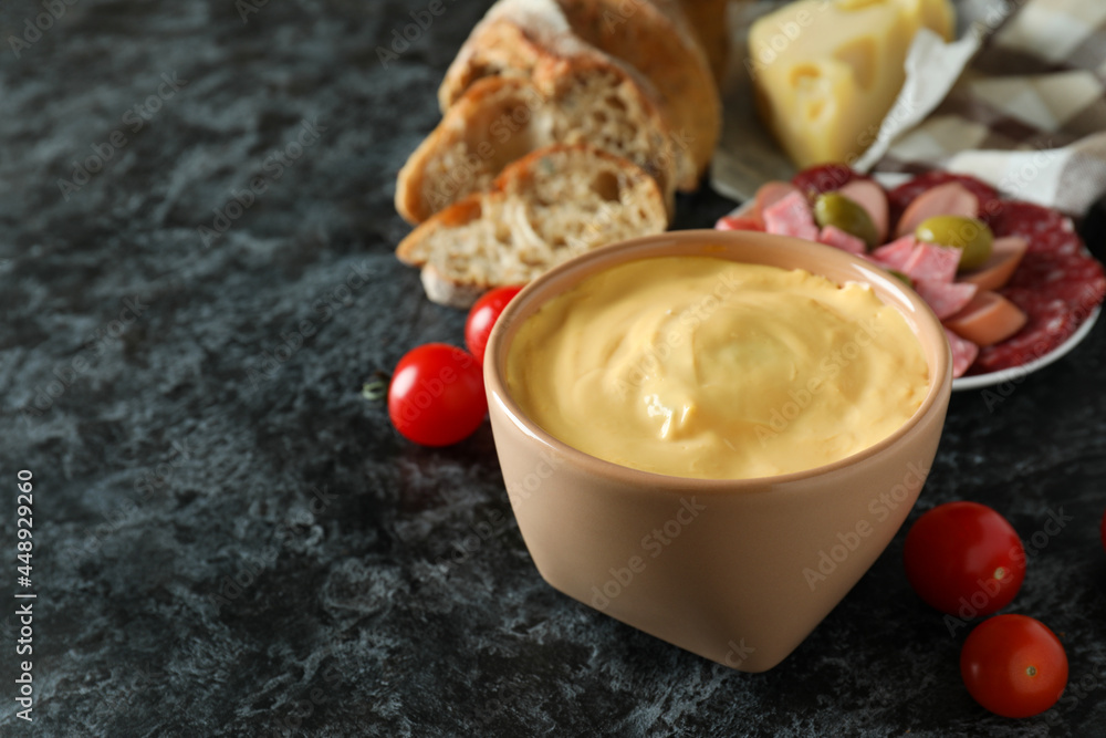 Concept of delicious food with fondue on black smokey table Concept of delicious food with fondue on black smokey table