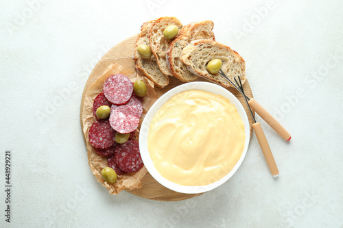 Concept of delicious food with fondue on white textured table