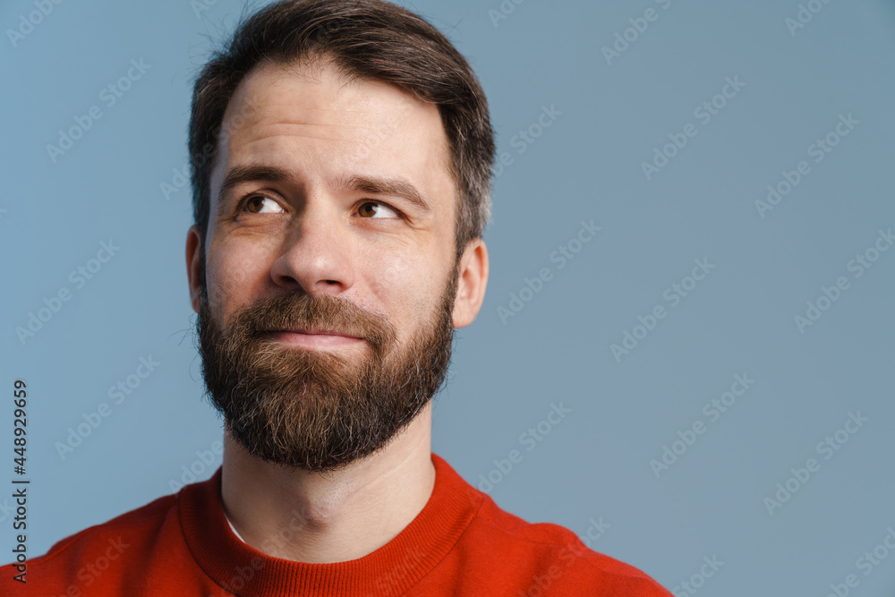 Fototapeta premium Brunette white man with beard smiling and looking aside