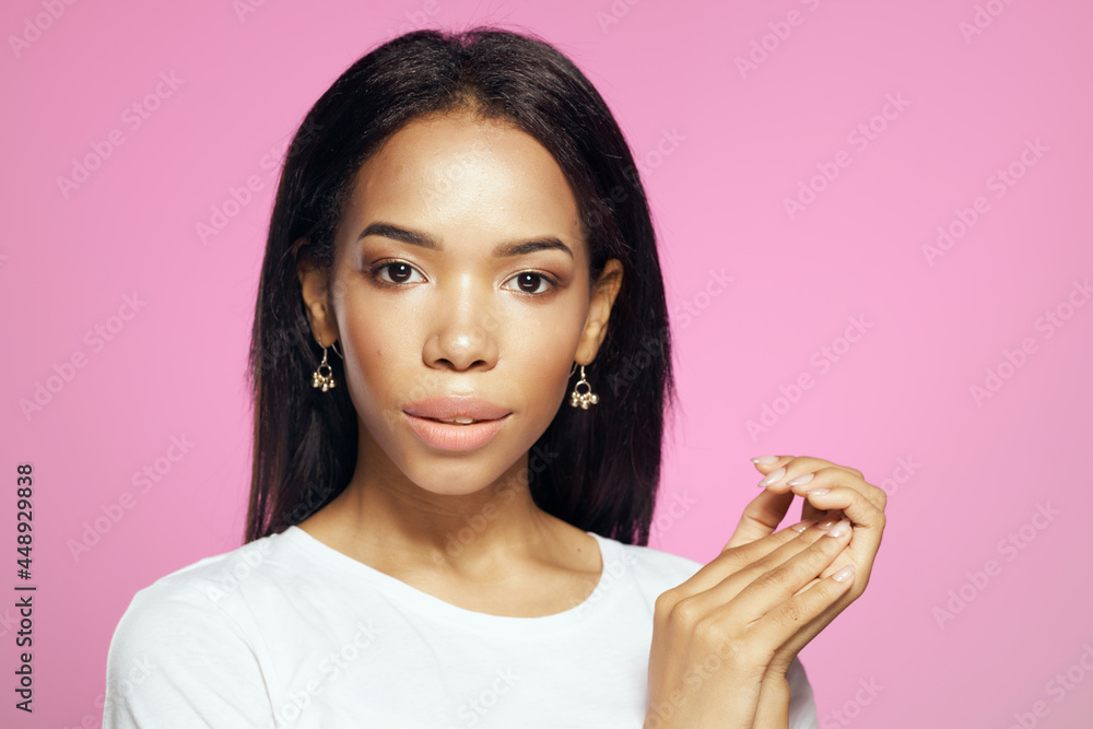 pretty african woman long hair white t-shirt pink background pretty african woman long hair white t-shirt pink background