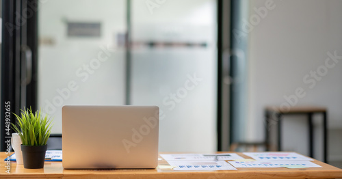 Wallpaper Mural design of workplace with laptop and many financial report on wooden desk at home office. Torontodigital.ca